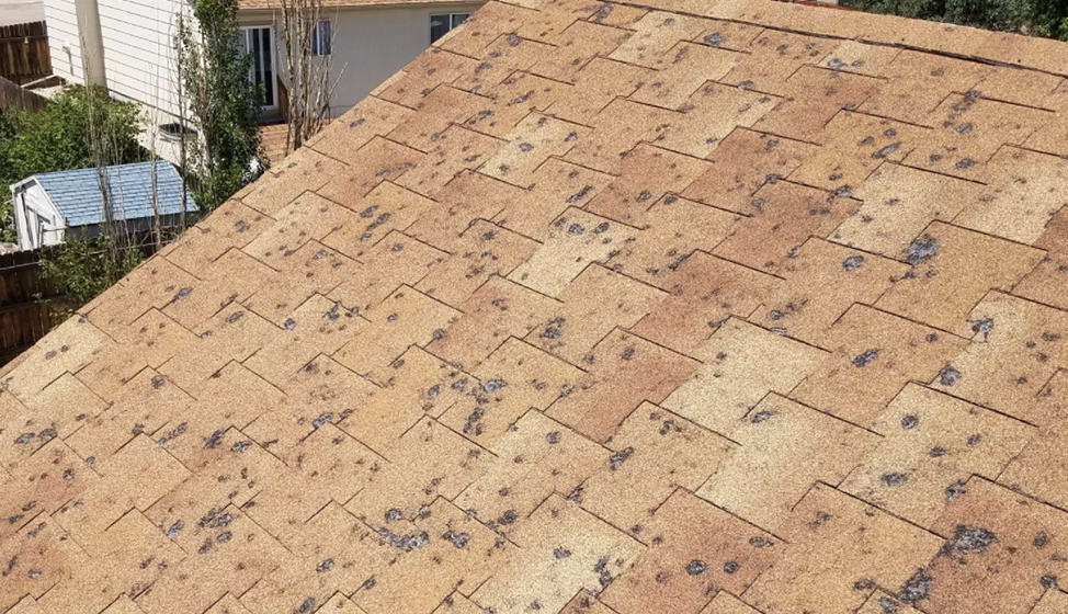 Roof damaged by hail. Time to call First General Services.
